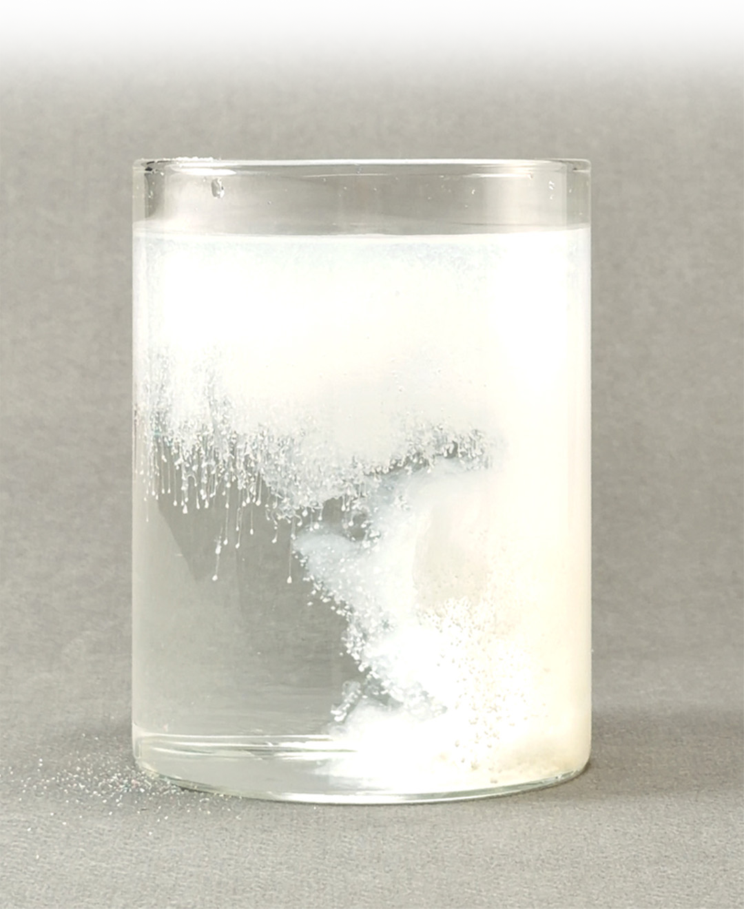 Infant formula powder dissolving in water to demonstrate easy mixing and solubility